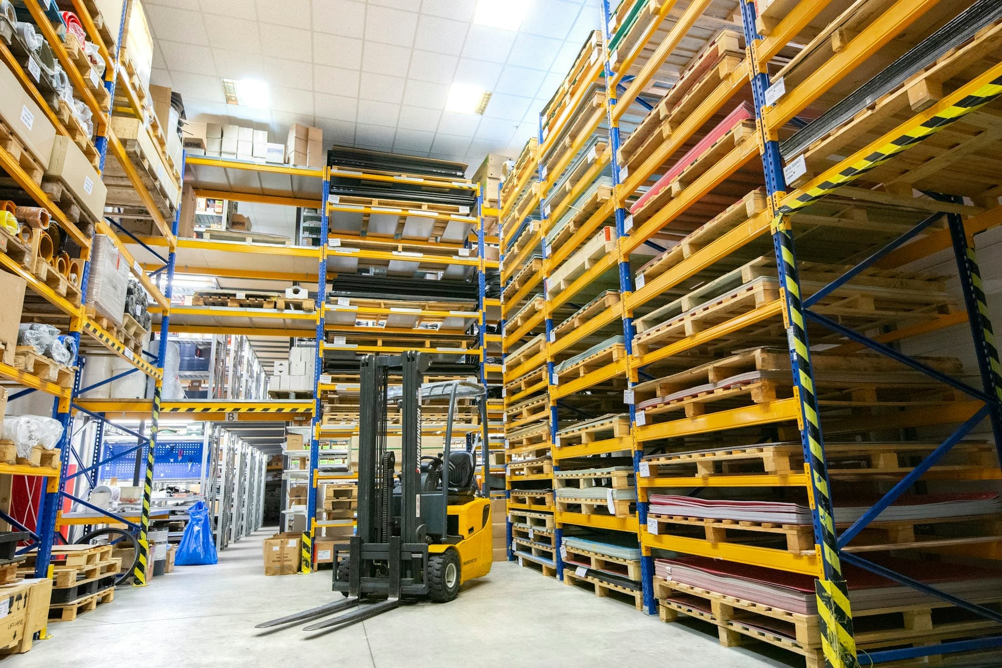 Pallet racking and a forklift inside a distribution warehouse