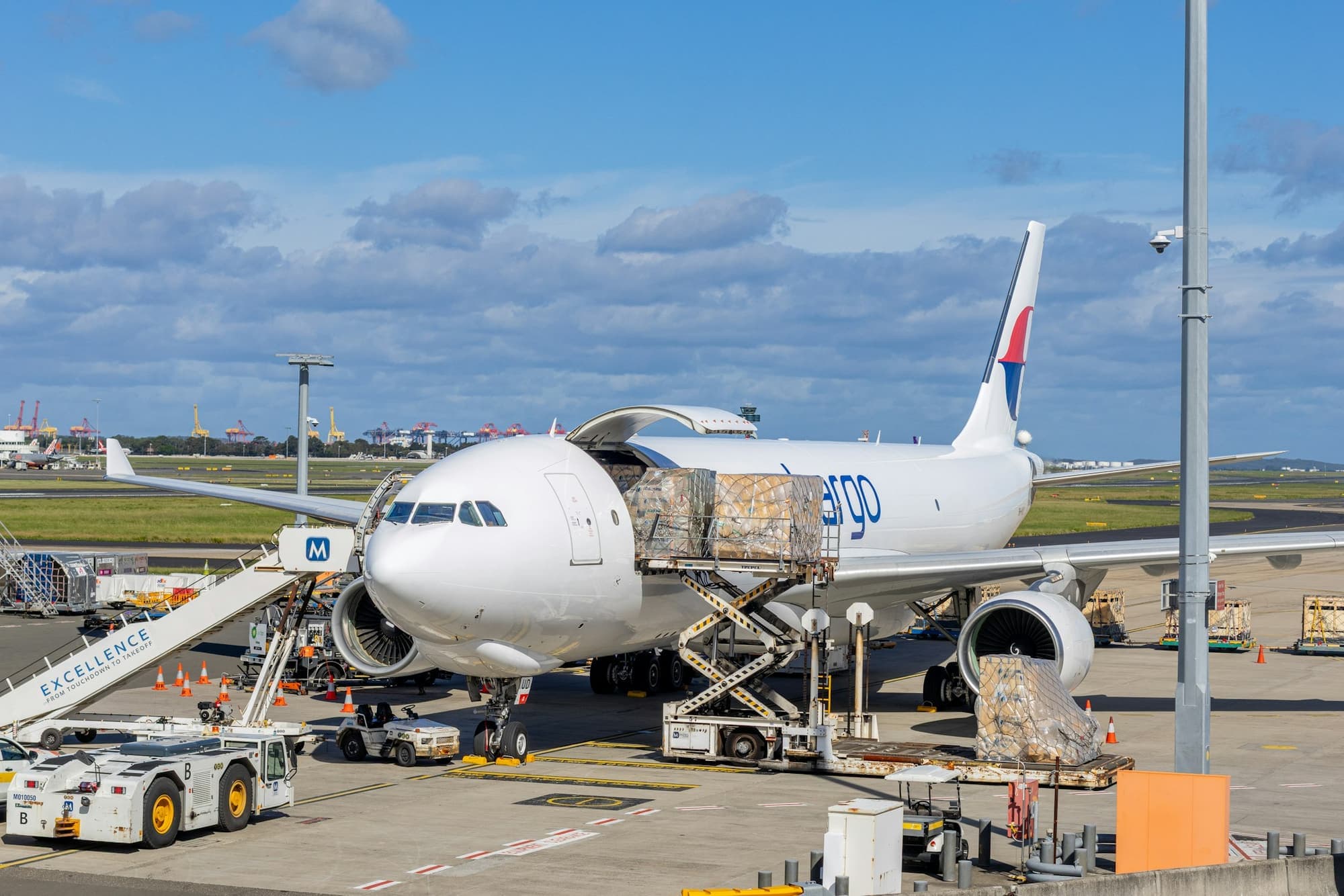 Cargo pallets being loaded through the side door of a freighter aircraft