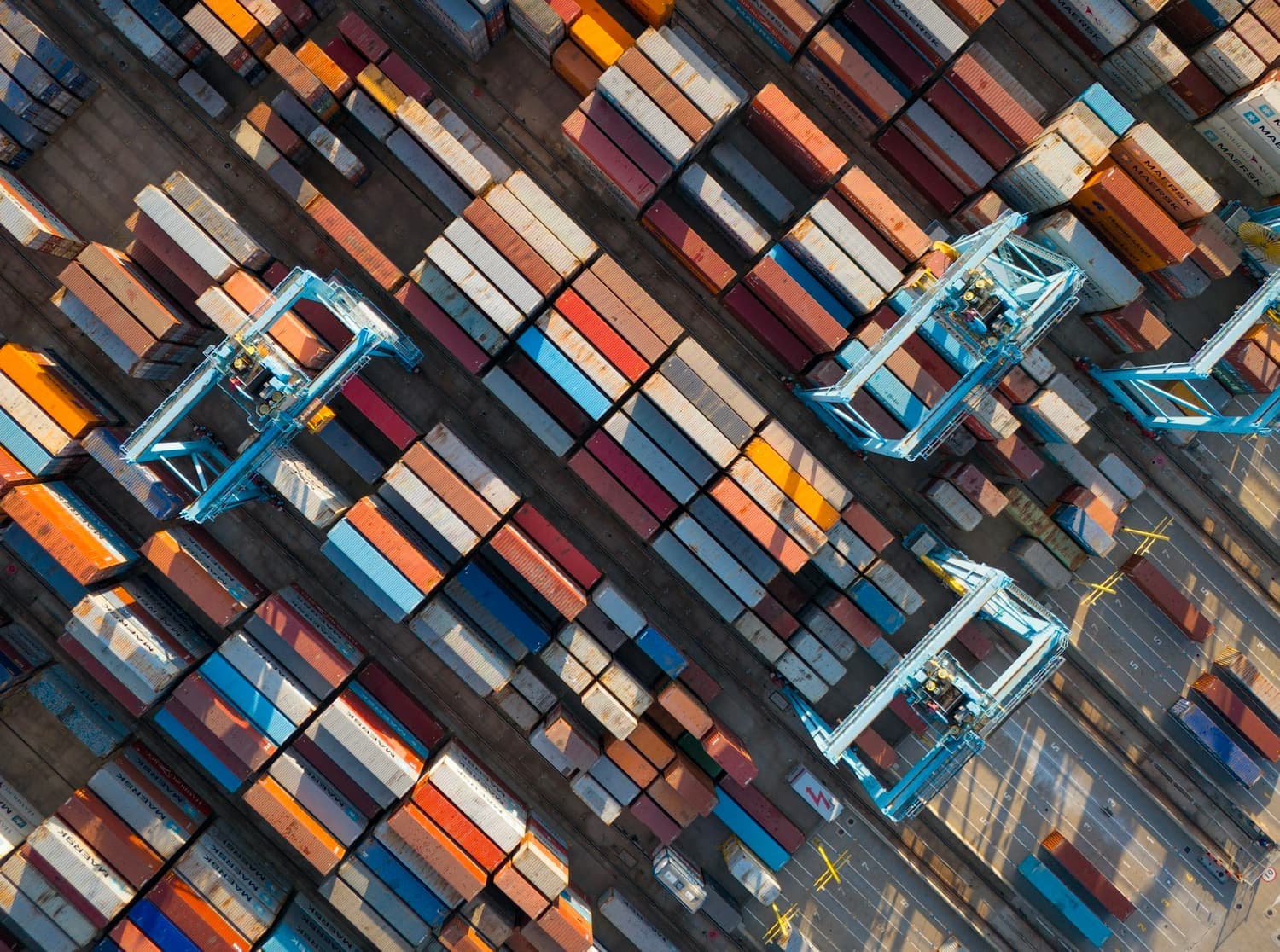 Aerial view of a container terminal, with straddle carriers moving between stacks
