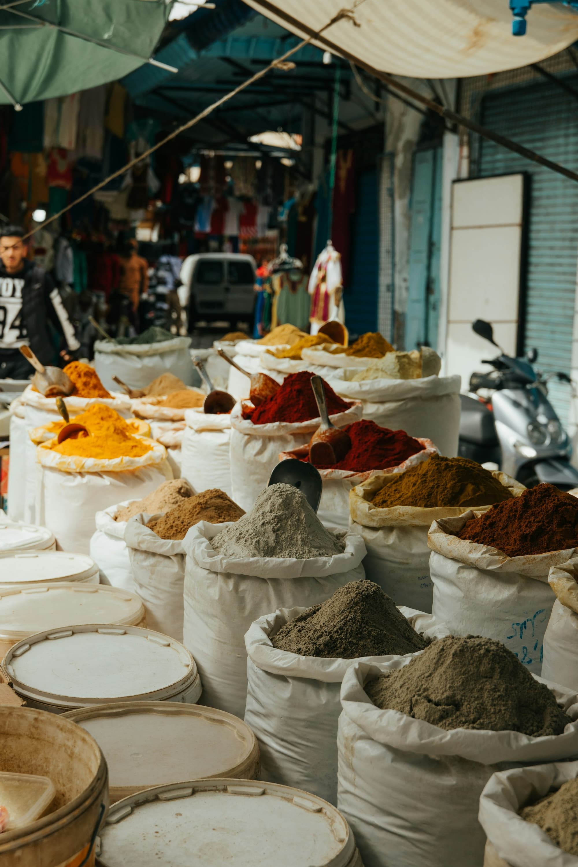 Open sacks of bulk turmeric, chilli and ground spices at a wholesale market